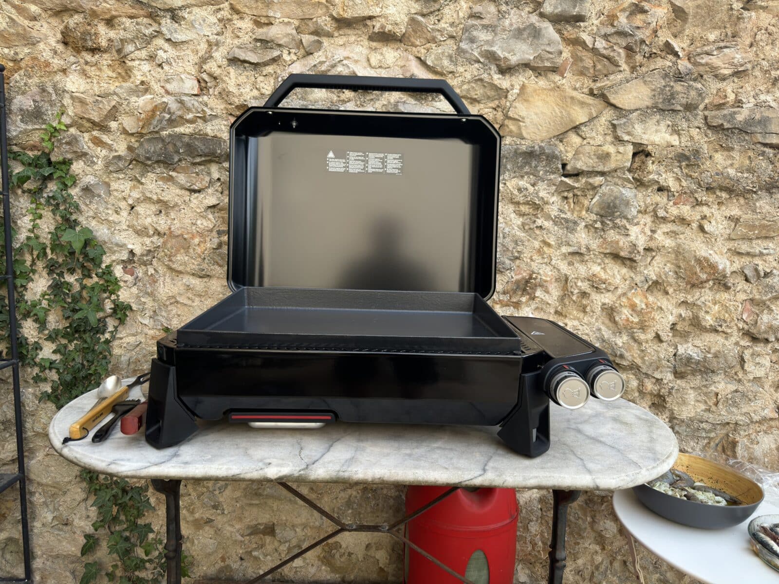 Vue de côté de la plancha avec des ustensiles à portée de main