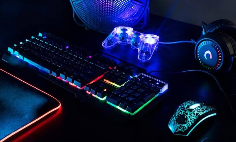 Vue d'un clavier gaming illuminé par des néons avec une manette.