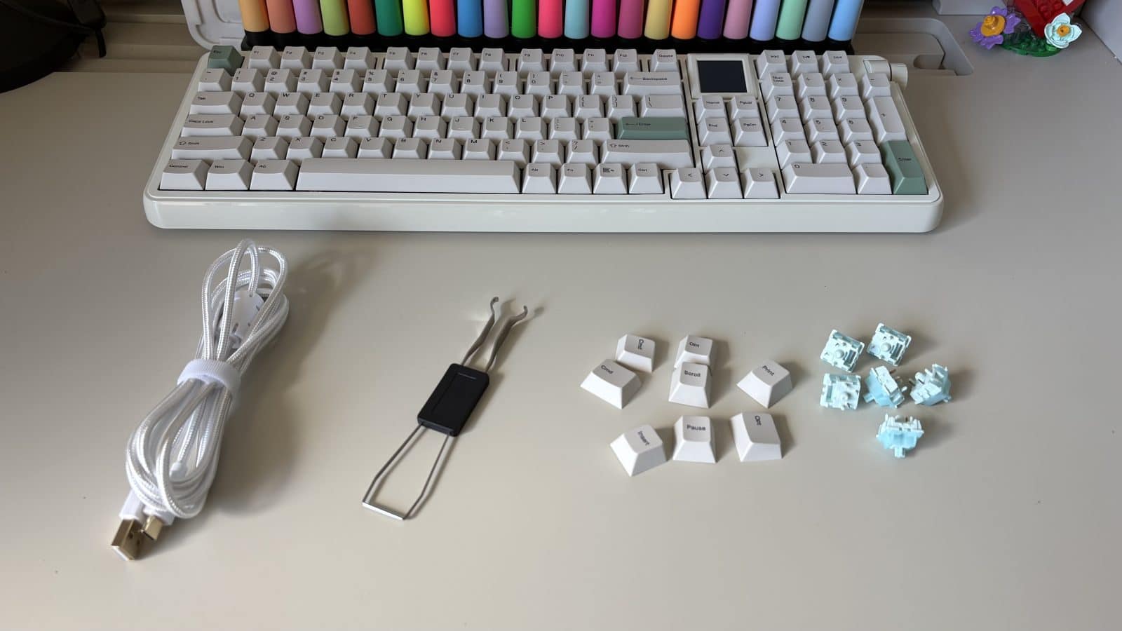 Tout ce que contient le carton du Epomaker RT100 Pro : Cable, pince, keycaps supplémentaires et switches d'appoint.