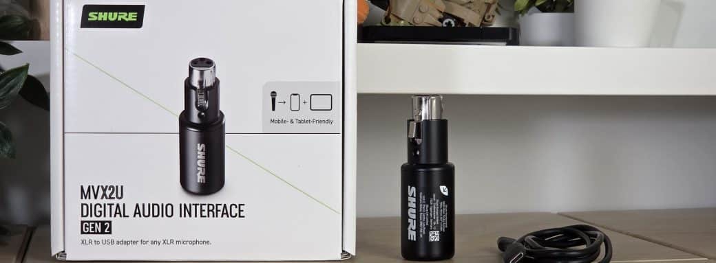 Interface Shure MVX2U Gen 2, sa boîte et son câble USB-C posés sur un bureau